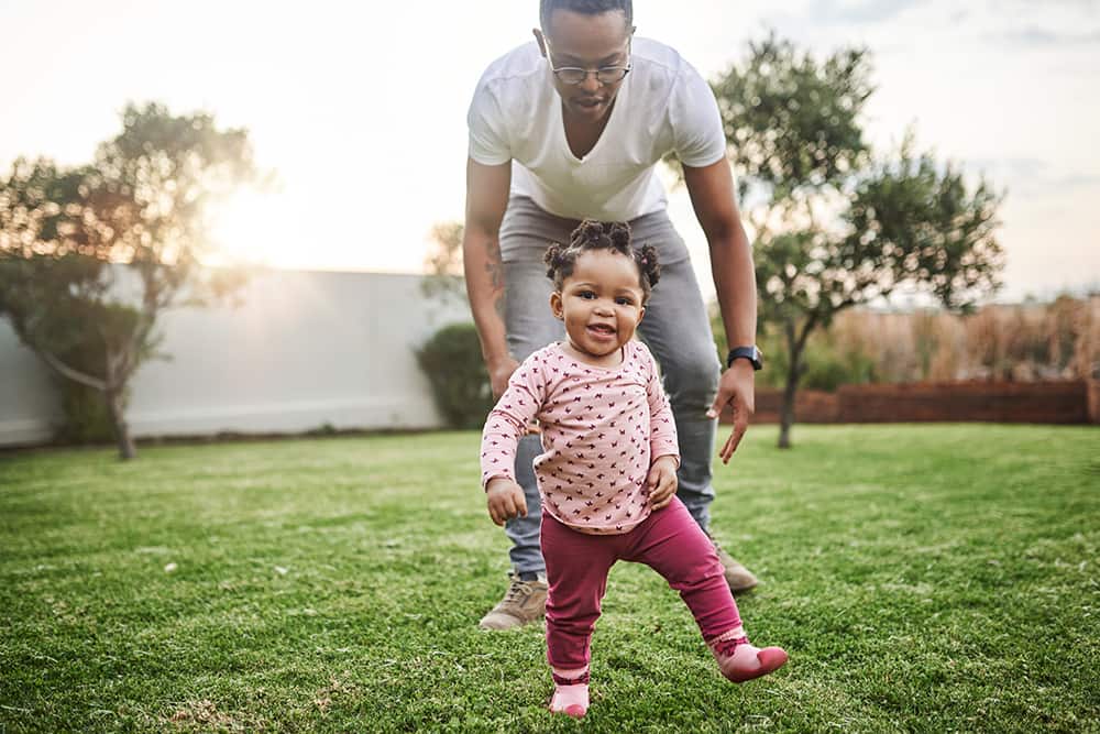 Dad walking with toddler